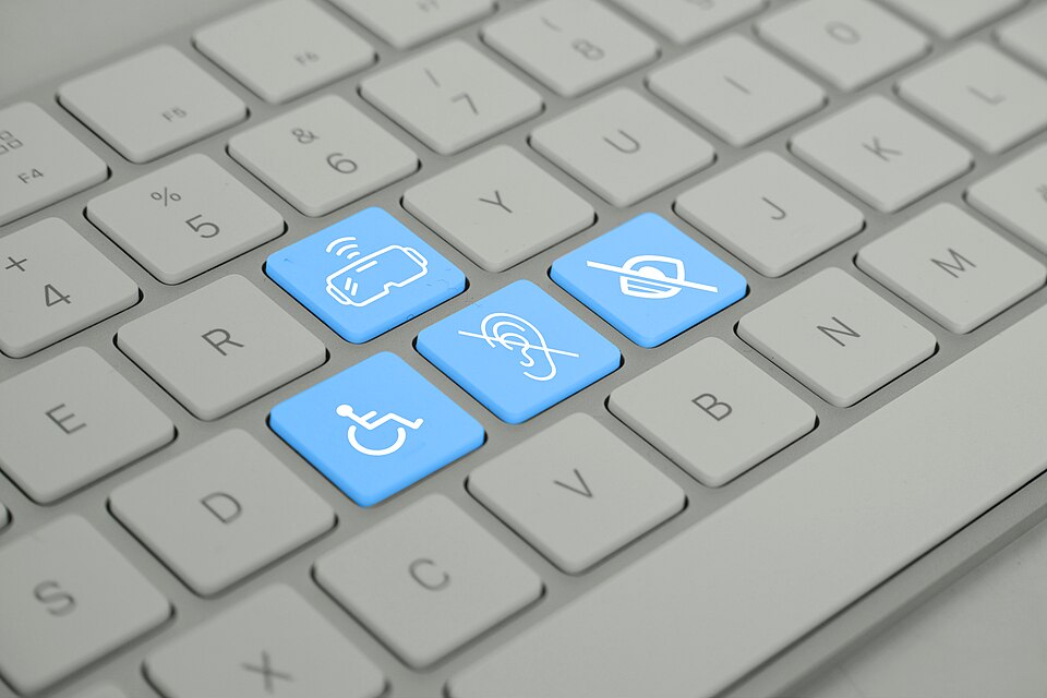 Keyboard with blue keys depicting different disabilities